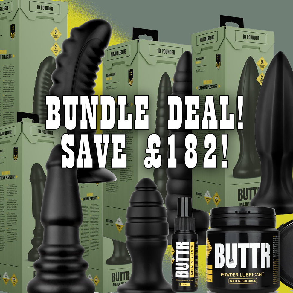 Promotional bundle graphic for adult products showing multiple black textured toys, several olive green product boxes, a small black bottle, and a black jar labeled BUTTR POWDER LUBRICANT, with large overlaid text reading 'BUNDLE DEAL! SAVE &182!'.