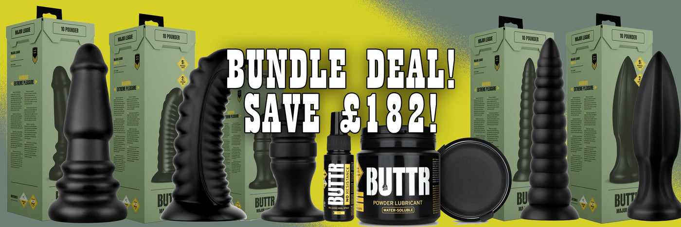 Promotional banner for a BUTTR bundle deal showing multiple black textured adult novelty products and their olive green retail boxes against a yellow-to-black gradient background, with large text reading 'BUNDLE DEAL! SAVE £182!'.