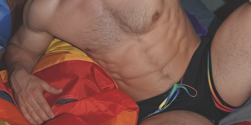 Person wearing a colorful swimsuit with a rainbow pattern.