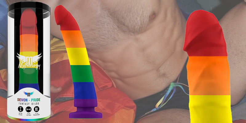 Rainbow-colored DILDOS on a blurred background.
