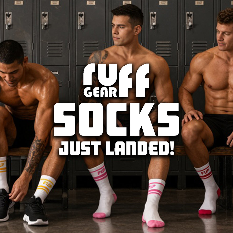 Three shirtless men sitting in a locker room wearing white athletic socks with pink and yellow accents. Large overlaid text reads 'RUFF GEAR SOCKS JUST LANDED!'.