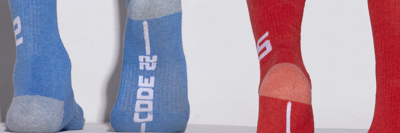 Blue and red socks with 'CODE 22' branding on a white background