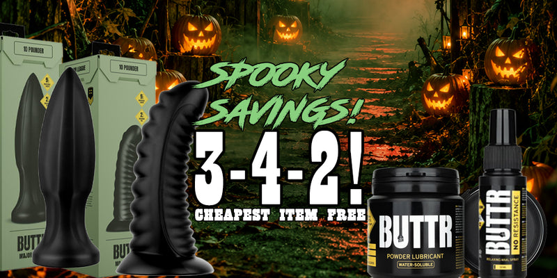 Promotional graphic for ButtRr brand adult novelty products, showing black textured silicone products and packaging against a Halloween forest background with jack-o'-lanterns and large sale text reading 'Spooky Savings! 3-4-2!'.