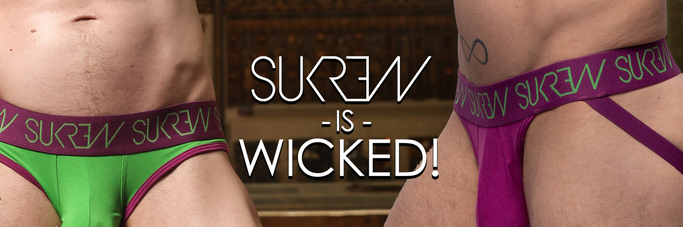 Two pairs of underwear with 'SUKREW' branding, one green and one purple, on a blurred background.